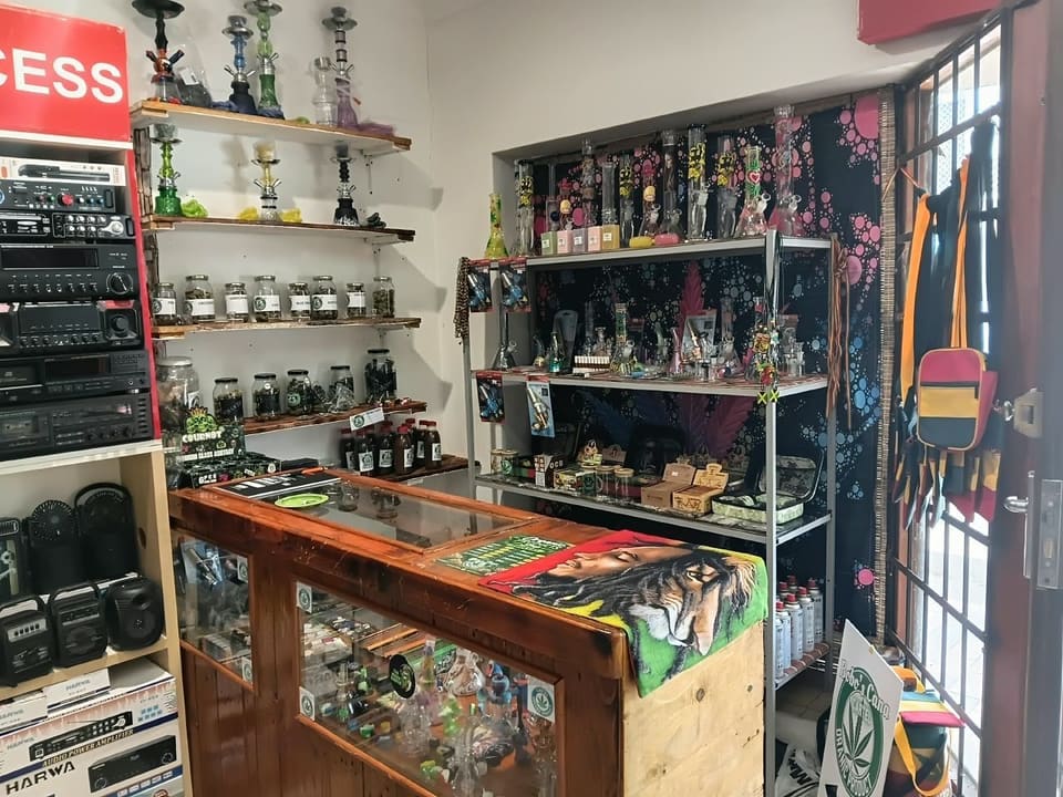 Side view of the shop showing the display counter, jar shelves and hookah wall