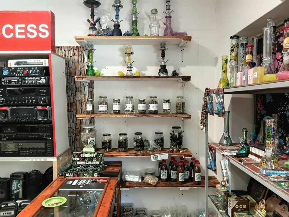 Wall of hookahs and shelves of labelled herb jars at the shop