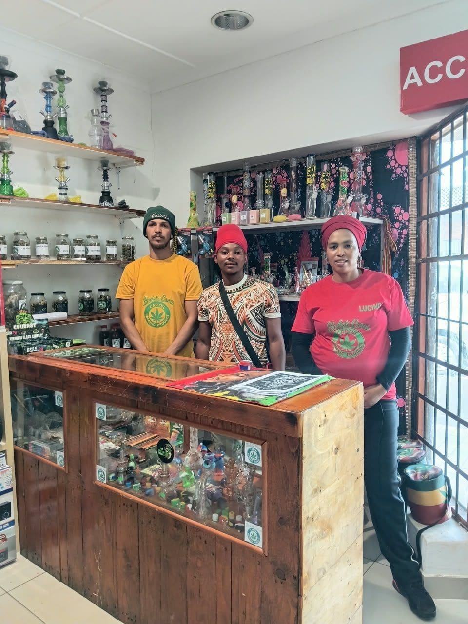 The three-person Bobo's Cana Cartel team standing behind the counter in the shop