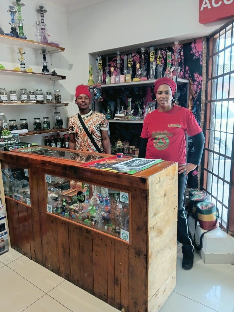 Two Bobo's Cana Cartel staff members behind the shop counter