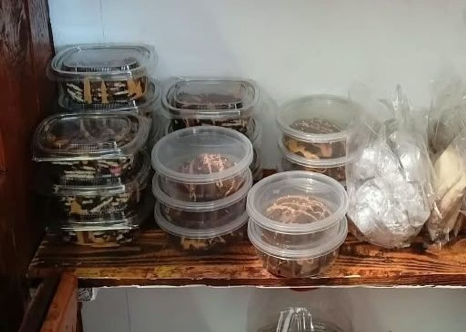 Clear containers of baked goods and sweets on the edibles shelf